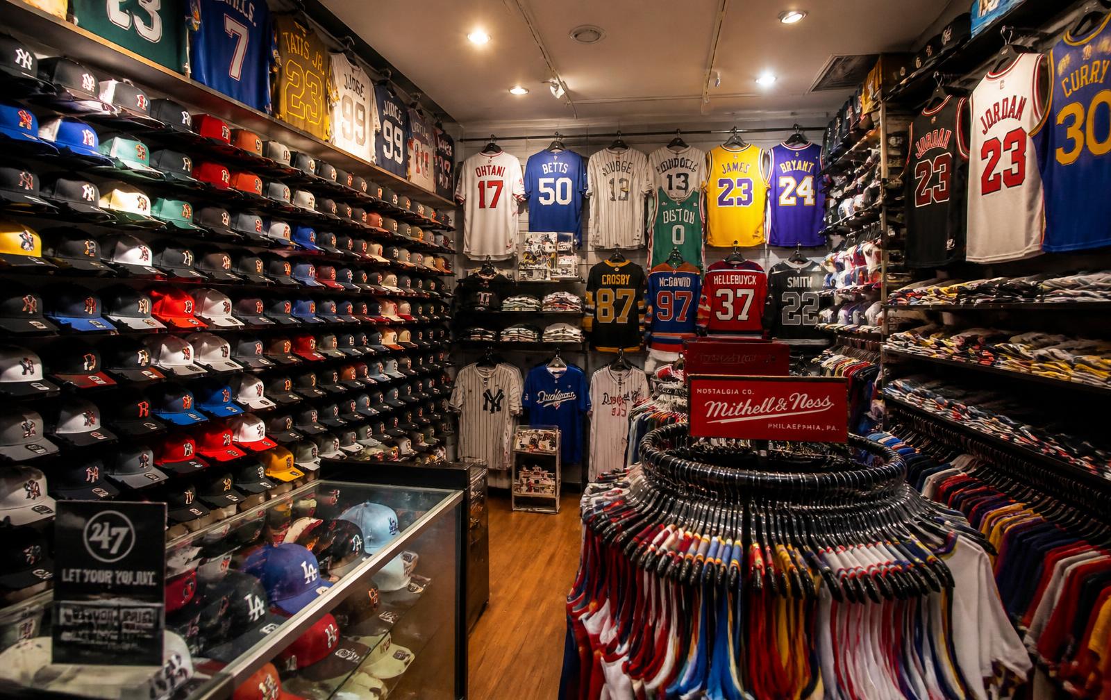 Interior of Pro Stop Sportswear packed with team hats and jerseys